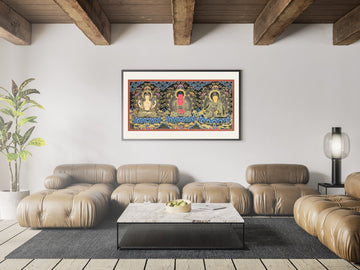 Hand-painted thangka of Chenrezig, Amitabha Buddha and Padmasambhava side by side, framed above a sofa