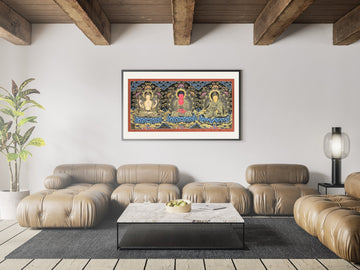 Hand-painted thangka of Chenrezig, Amitabha Buddha and Padmasambhava side by side, framed above a sofa