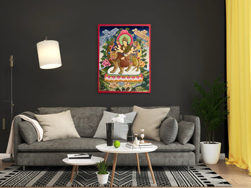 Hand-painted Durga thangka above a grey sofa: the many-armed goddess rides a tiger