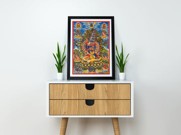 Hand-painted Kagye thangka of the Eight Herukas in a black frame on a small cabinet: a wrathful deity at the centre, surrounded by the other herukas