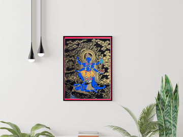 Hand-painted Kali thangka in black and gold, framed on a white wall: the blue goddess stands on Shiva