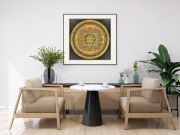 Hand-painted Shakyamuni Buddha mandala in gold and black, framed above a table: the Buddha sits at the centre of the palace