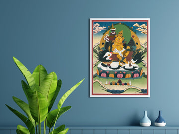 Hand-painted Vaishravana thangka in a white frame on a blue wall: the yellow guardian king rides a white snow lion