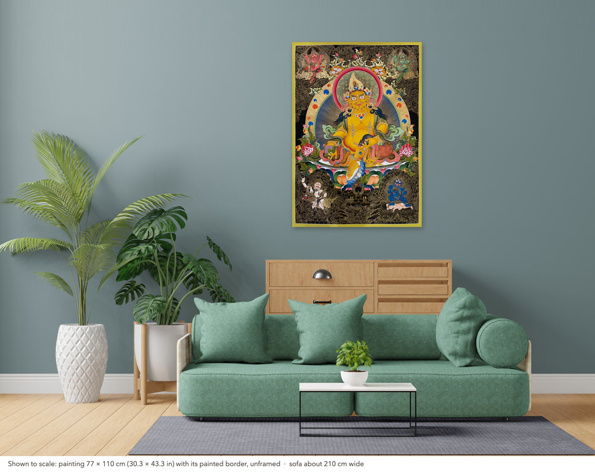 Jambhala thangka shown to scale in a living room, unframed, above a sofa about 210 cm wide (77×110 cm)