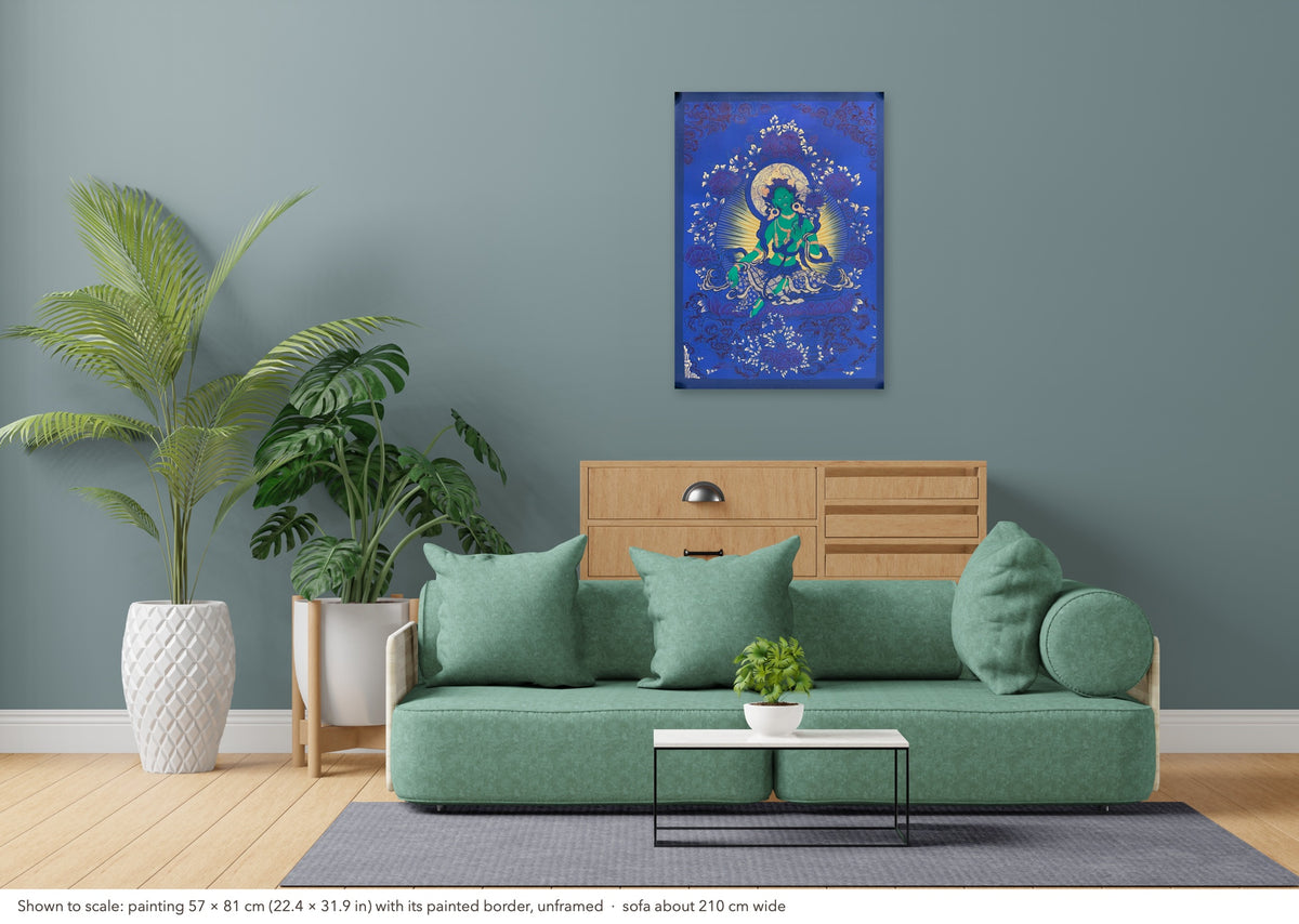 Green Tara thangka shown to scale in a living room, unframed, above a sofa about 210 cm wide (57×81 cm)
