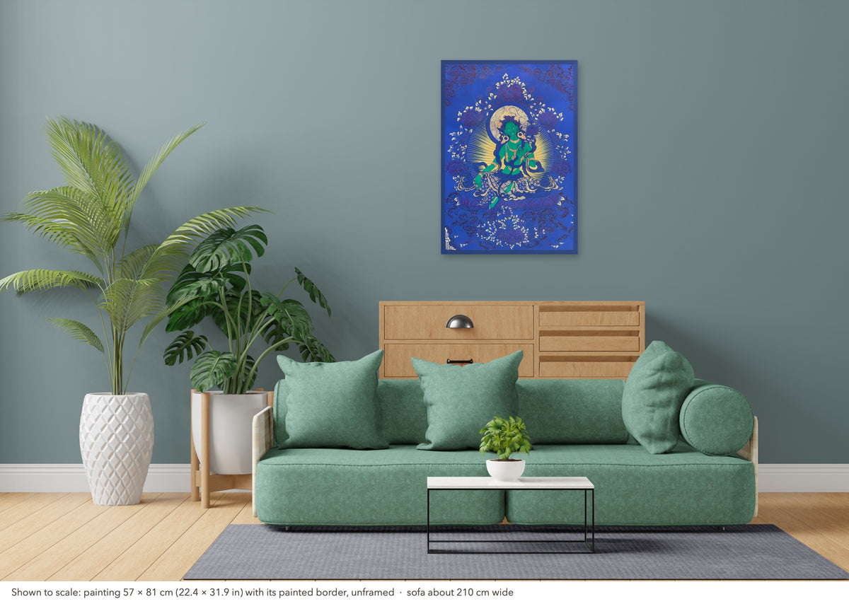 Green Tara thangka shown to scale in a living room, unframed, above a sofa about 210 cm wide (57×81 cm)