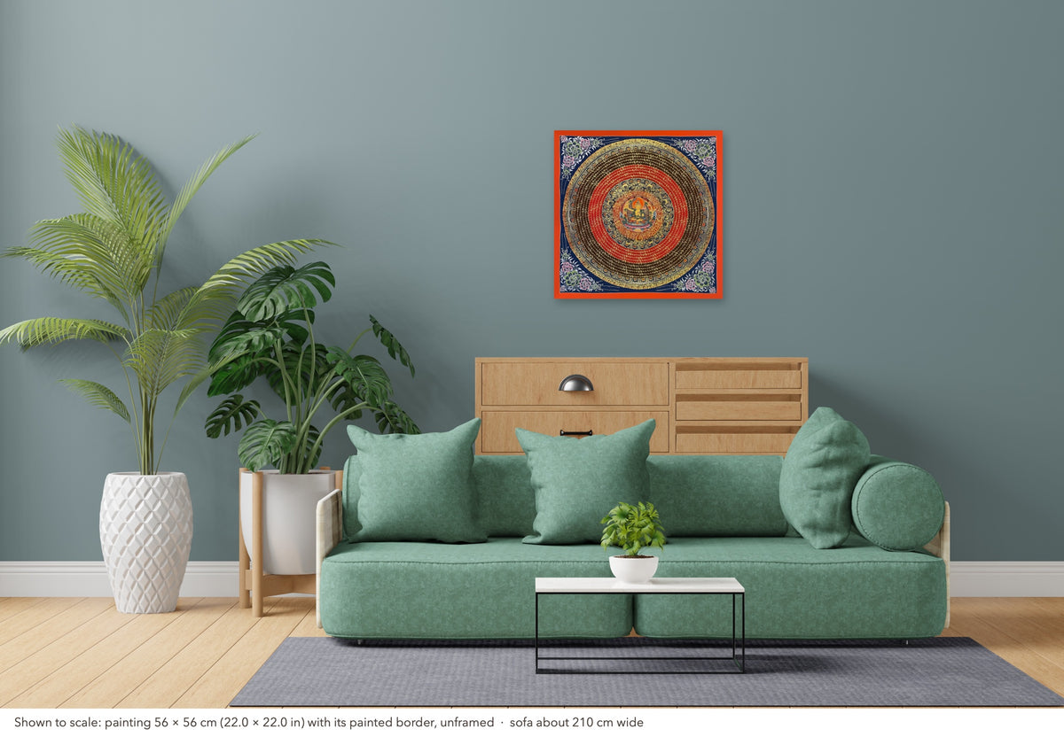 Manjushri Mantra Mandala thangka shown to scale in a living room, unframed, above a sofa about 210 cm wide (56×56 cm)
