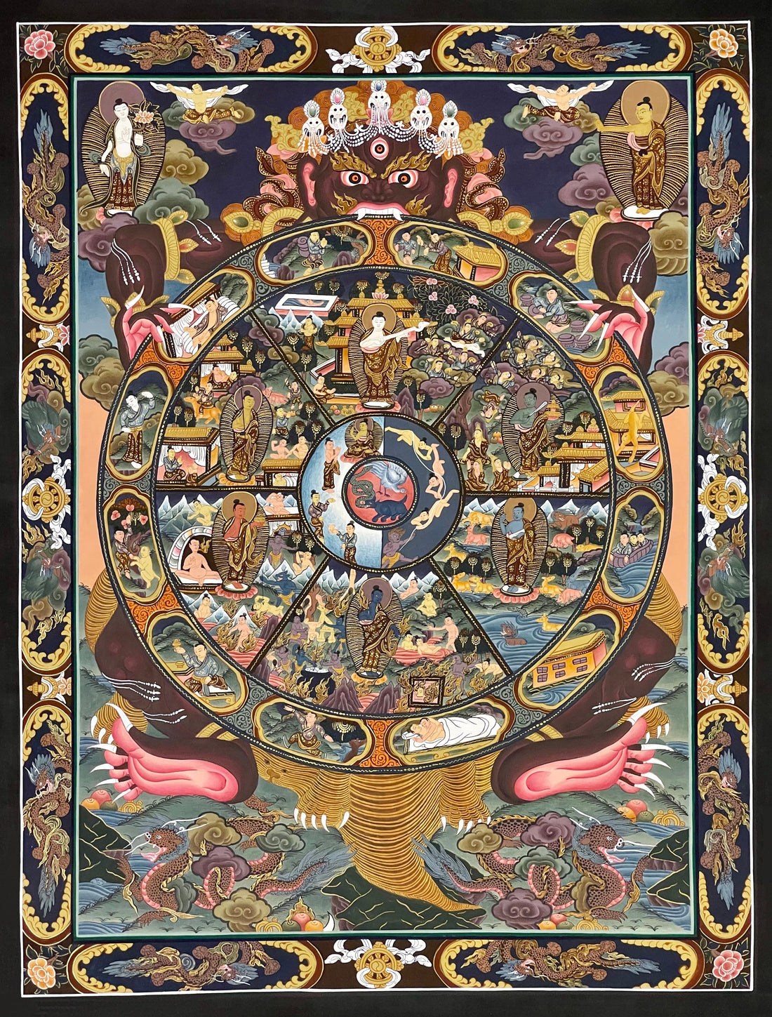Wheel of Life thangka, 47×60 cm: dark Yama holding the Wheel of Life with a Buddha in each realm, framed by a navy and gold border of dragons