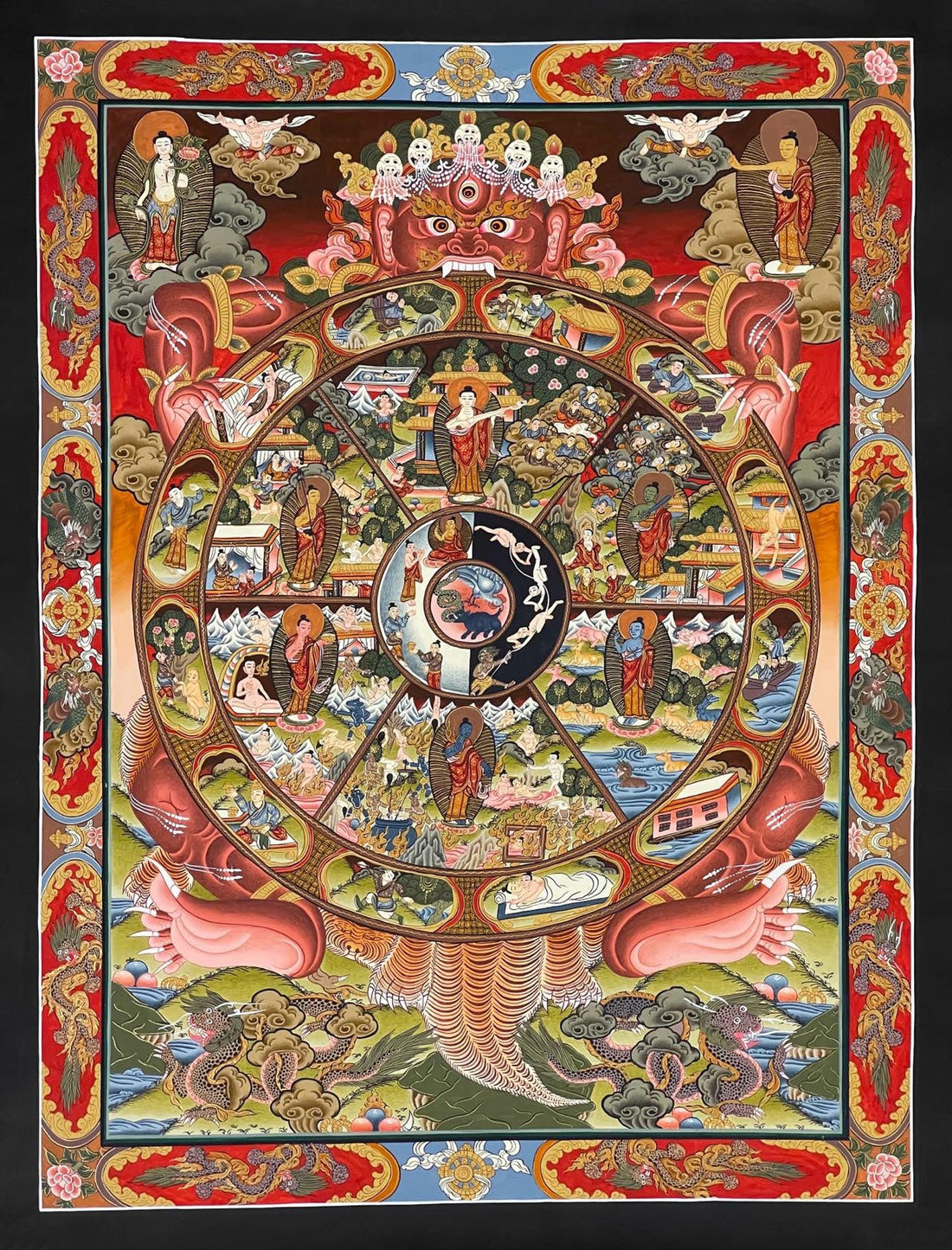 Wheel of Life thangka, 47×60 cm: red Yama holding the Wheel of Life with a Buddha in each realm, framed by a red and gold border of dragons