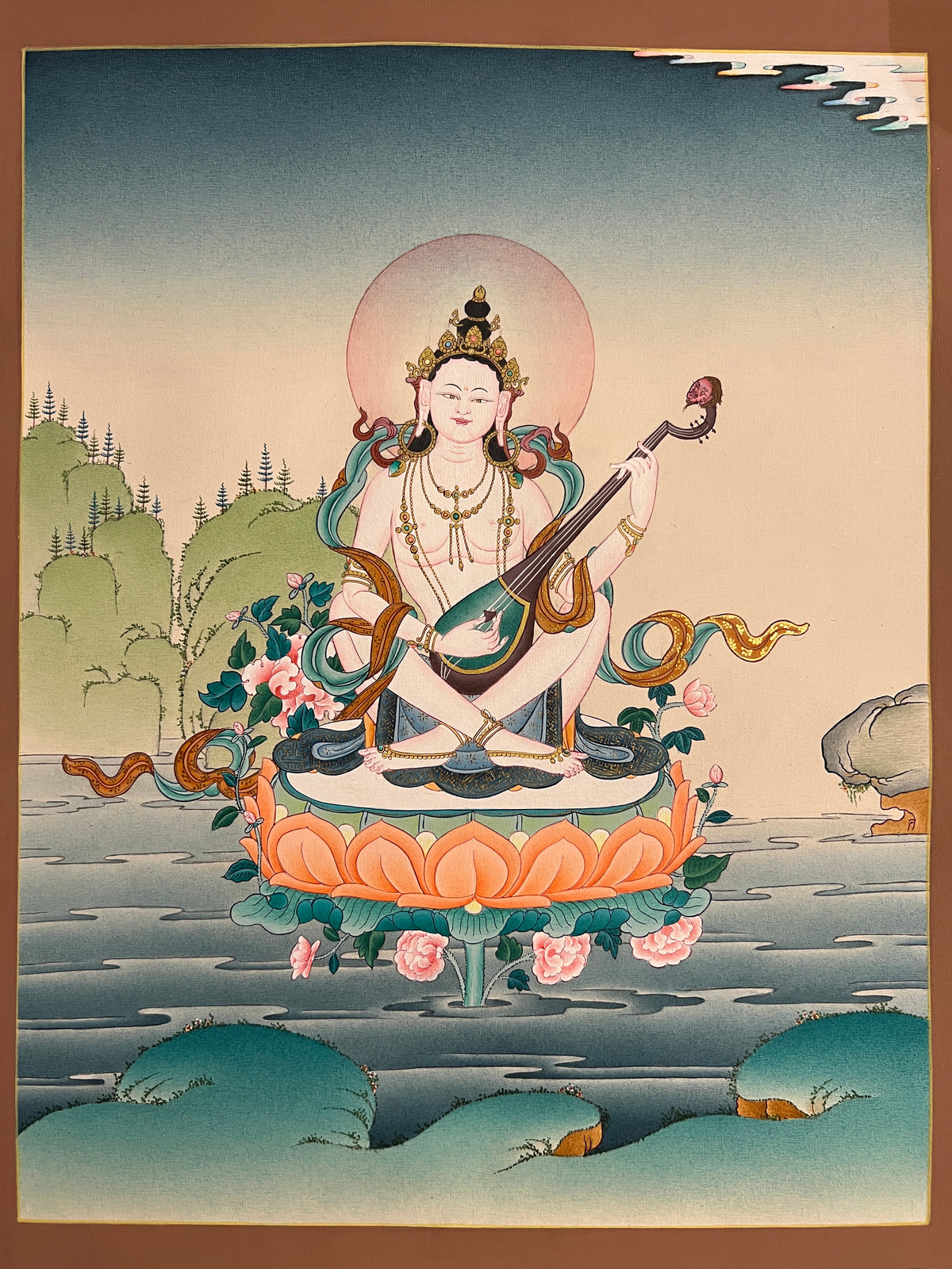 Saraswati thangka, 35×45 cm: Saraswati playing a vina on a lotus rising from water, in a calm, open landscape