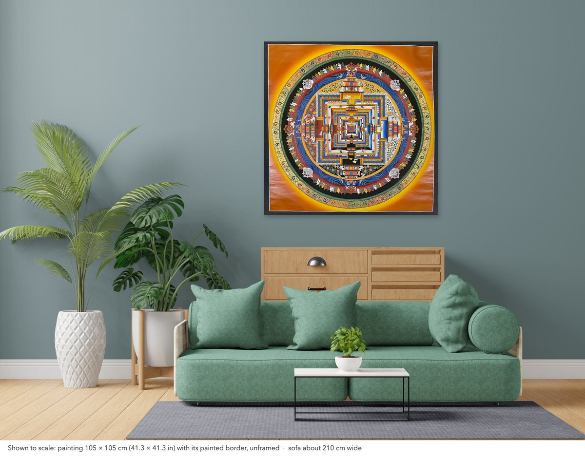 Kalachakra Mandala thangka shown to scale in a living room, unframed, above a sofa about 210 cm wide (105×105 cm)