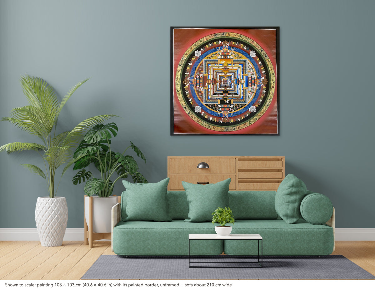 Kalachakra Mandala thangka shown to scale in a living room, unframed, above a sofa about 210 cm wide (103×103 cm)