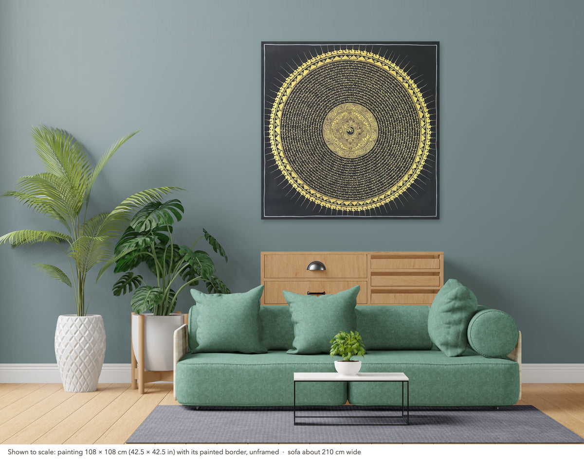 Mantra Mandala thangka shown to scale in a living room, unframed, above a sofa about 210 cm wide (108×108 cm)