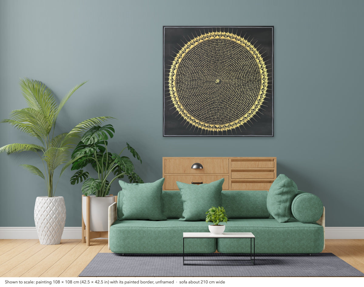 Mantra Mandala thangka shown to scale in a living room, unframed, above a sofa about 210 cm wide (108×108 cm)