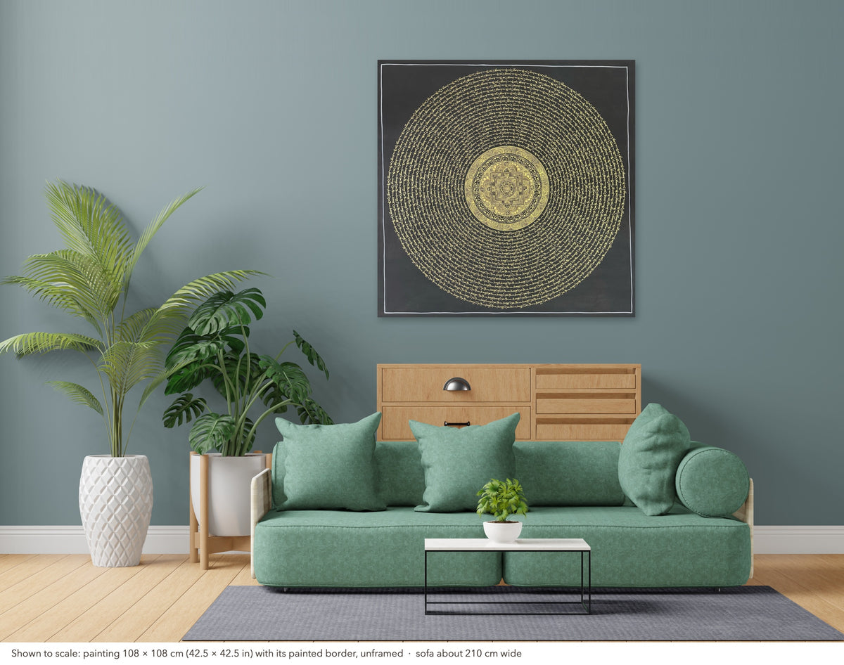 Mantra Mandala thangka shown to scale in a living room, unframed, above a sofa about 210 cm wide (108×108 cm)