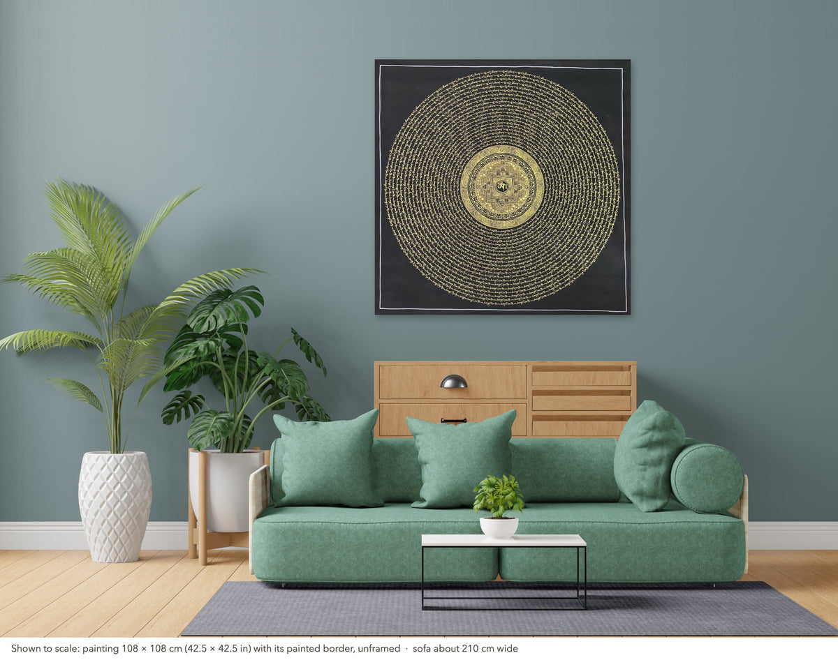 Mantra Mandala thangka shown to scale in a living room, unframed, above a sofa about 210 cm wide (108×108 cm)