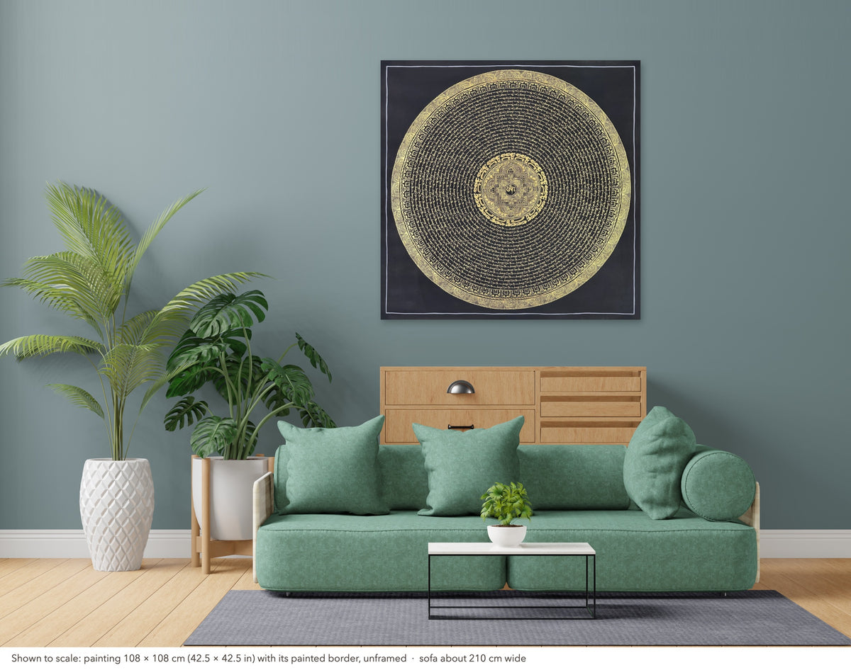 Mantra Mandala thangka shown to scale in a living room, unframed, above a sofa about 210 cm wide (108×108 cm)