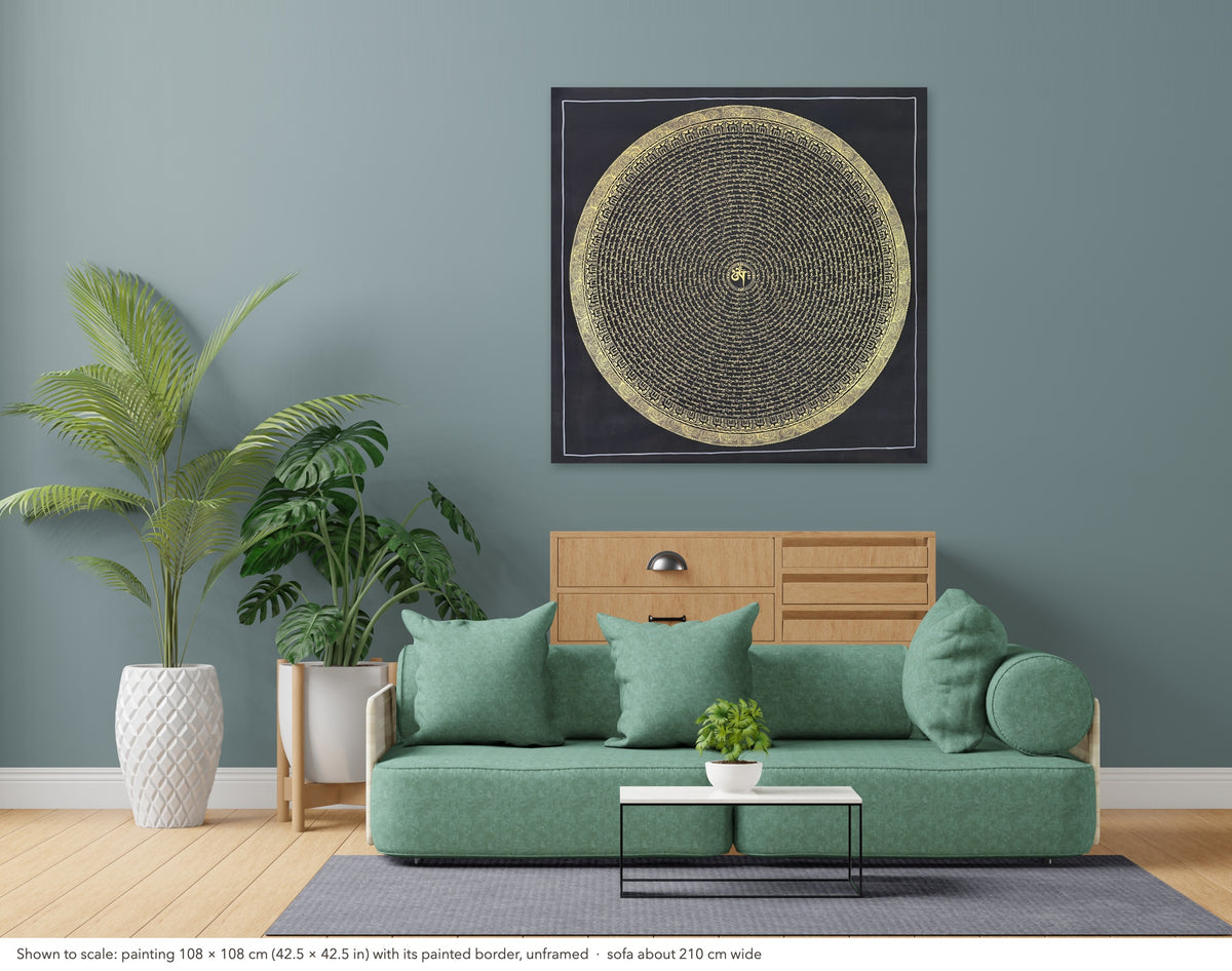 Mantra Mandala thangka shown to scale in a living room, unframed, above a sofa about 210 cm wide (108×108 cm)