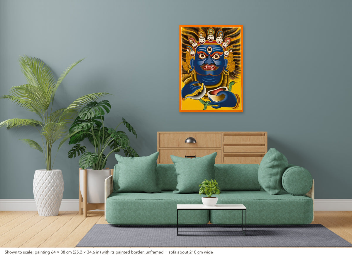 Mahakala thangka shown to scale in a living room, unframed, above a sofa about 210 cm wide (64×88 cm)