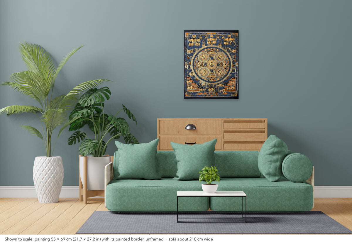 Buddha Mandala thangka shown to scale in a living room, unframed, above a sofa about 210 cm wide (55×69 cm)