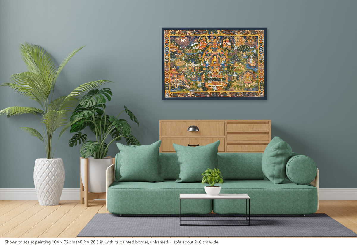 Buddha Life Story thangka shown to scale in a living room, unframed, above a sofa about 210 cm wide (104×72 cm)
