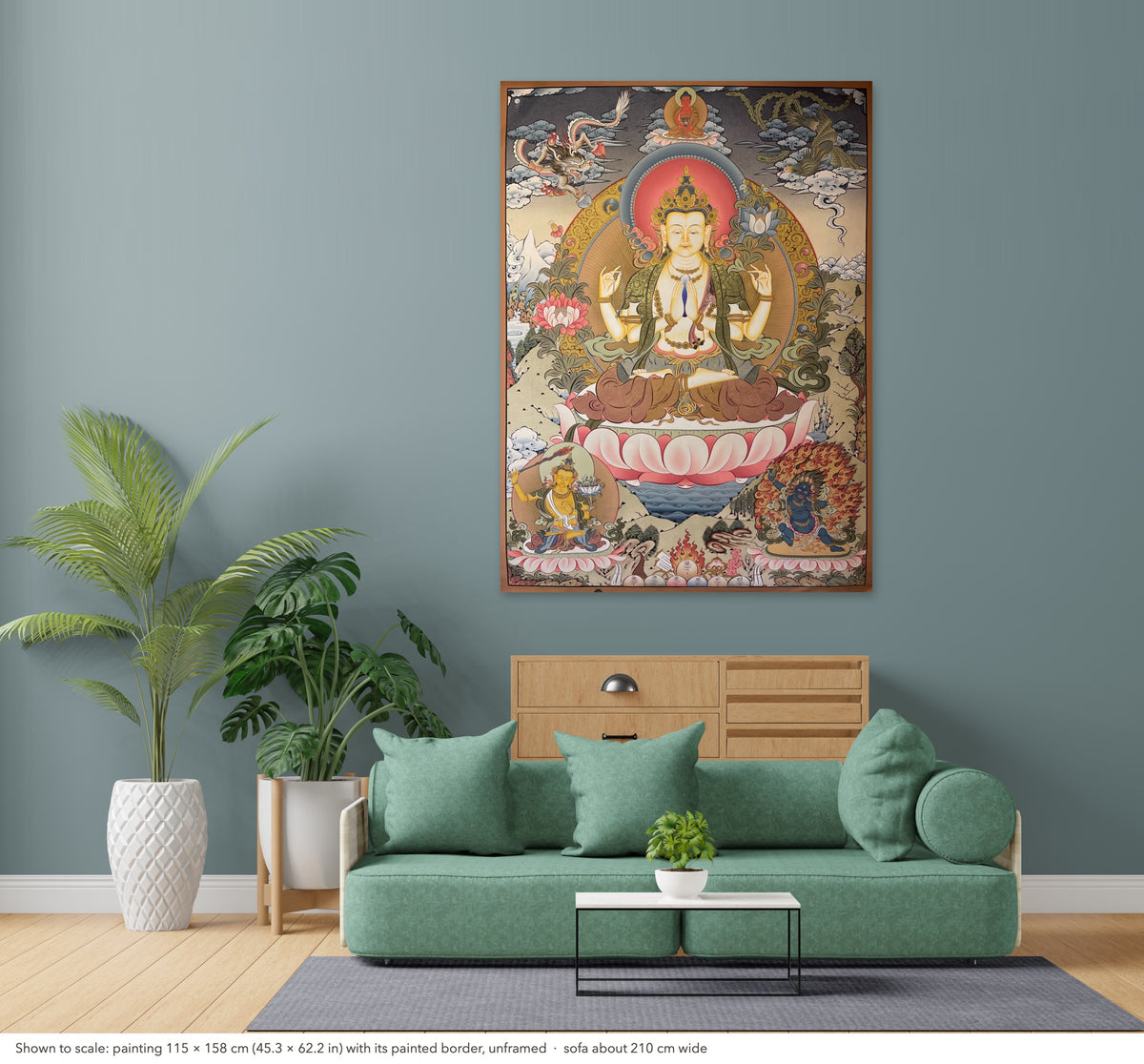 Chenrezig thangka shown to scale in a living room, unframed, above a sofa about 210 cm wide (115×158 cm)
