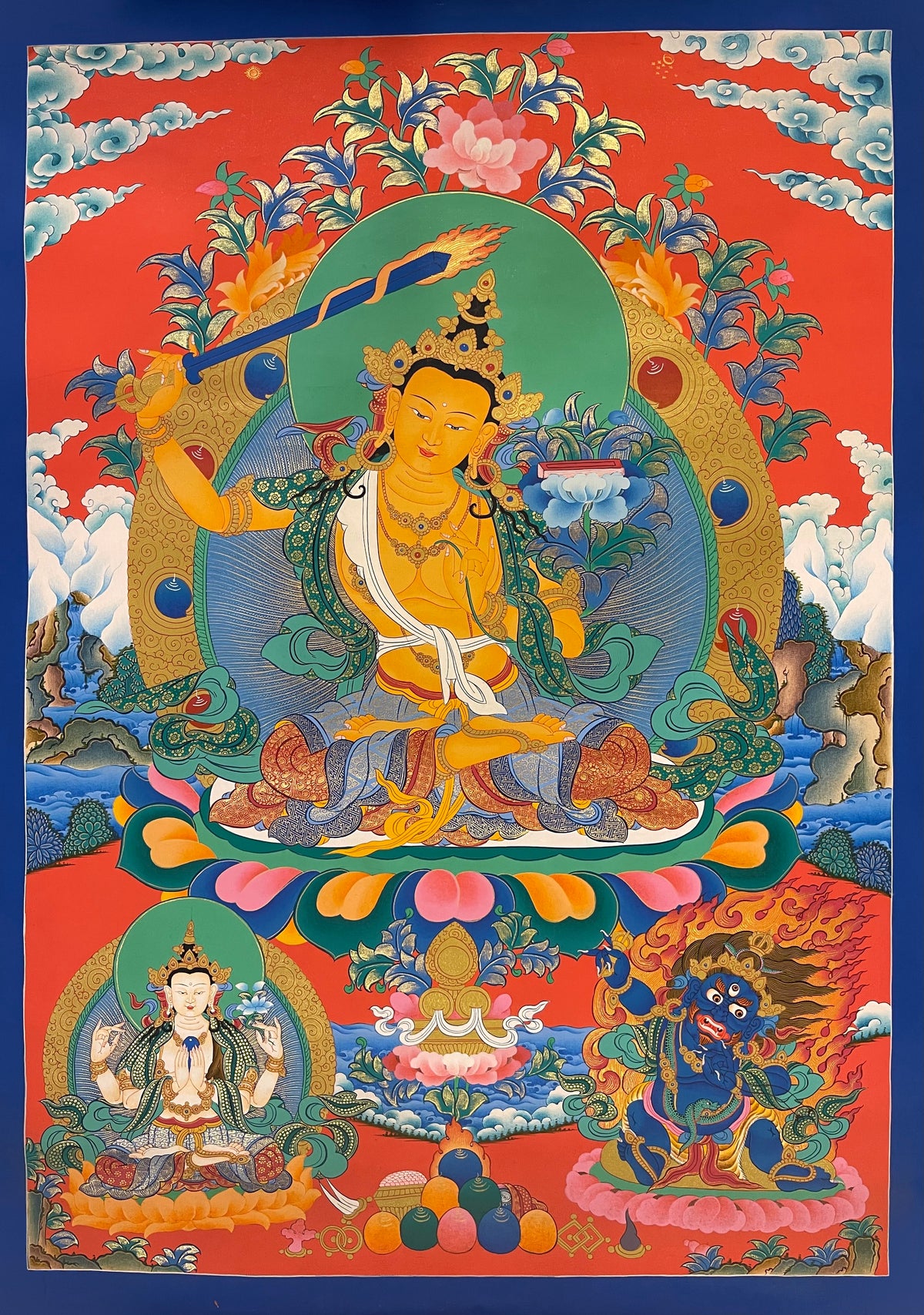 Manjushri thangka, 50×69 cm: Manjushri raising his flaming sword on a vermilion ground, with Chenrezig and a protector below