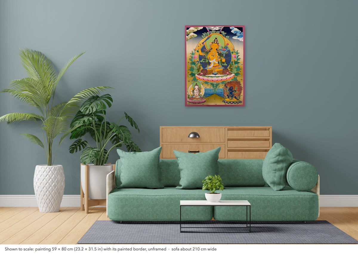 Manjushri thangka shown to scale in a living room, unframed, above a sofa about 210 cm wide (59×80 cm)