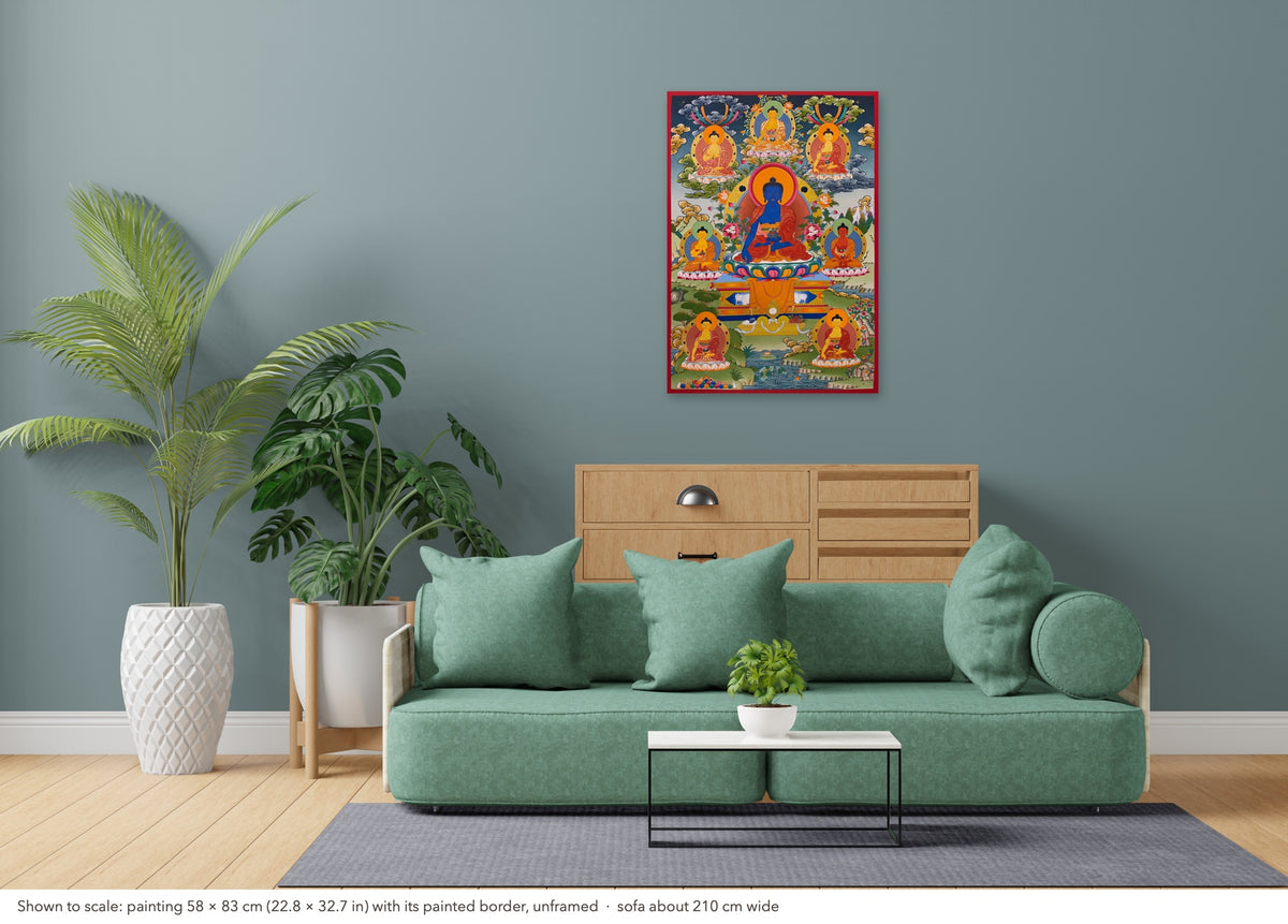 Medicine Buddha thangka shown to scale in a living room, unframed, above a sofa about 210 cm wide (58×83 cm)