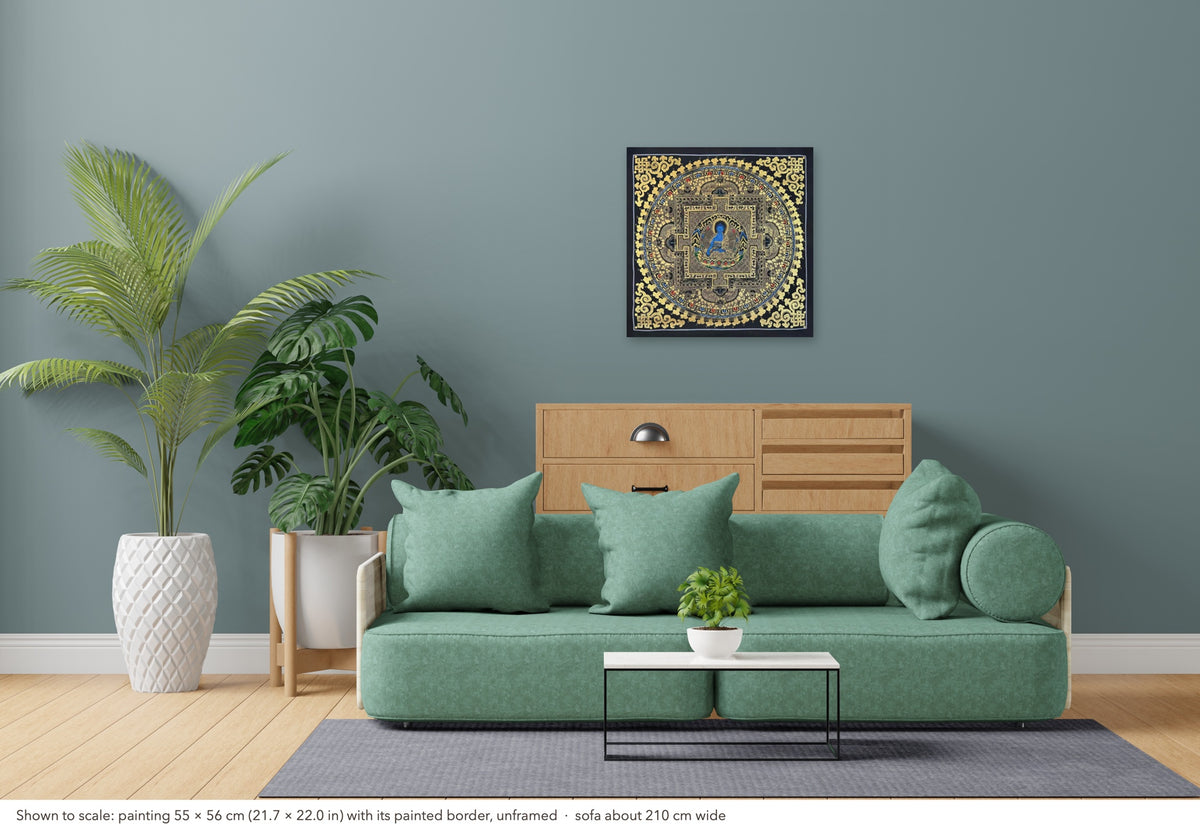Medicine Buddha Mandala thangka shown to scale in a living room, unframed, above a sofa about 210 cm wide (55×56 cm)
