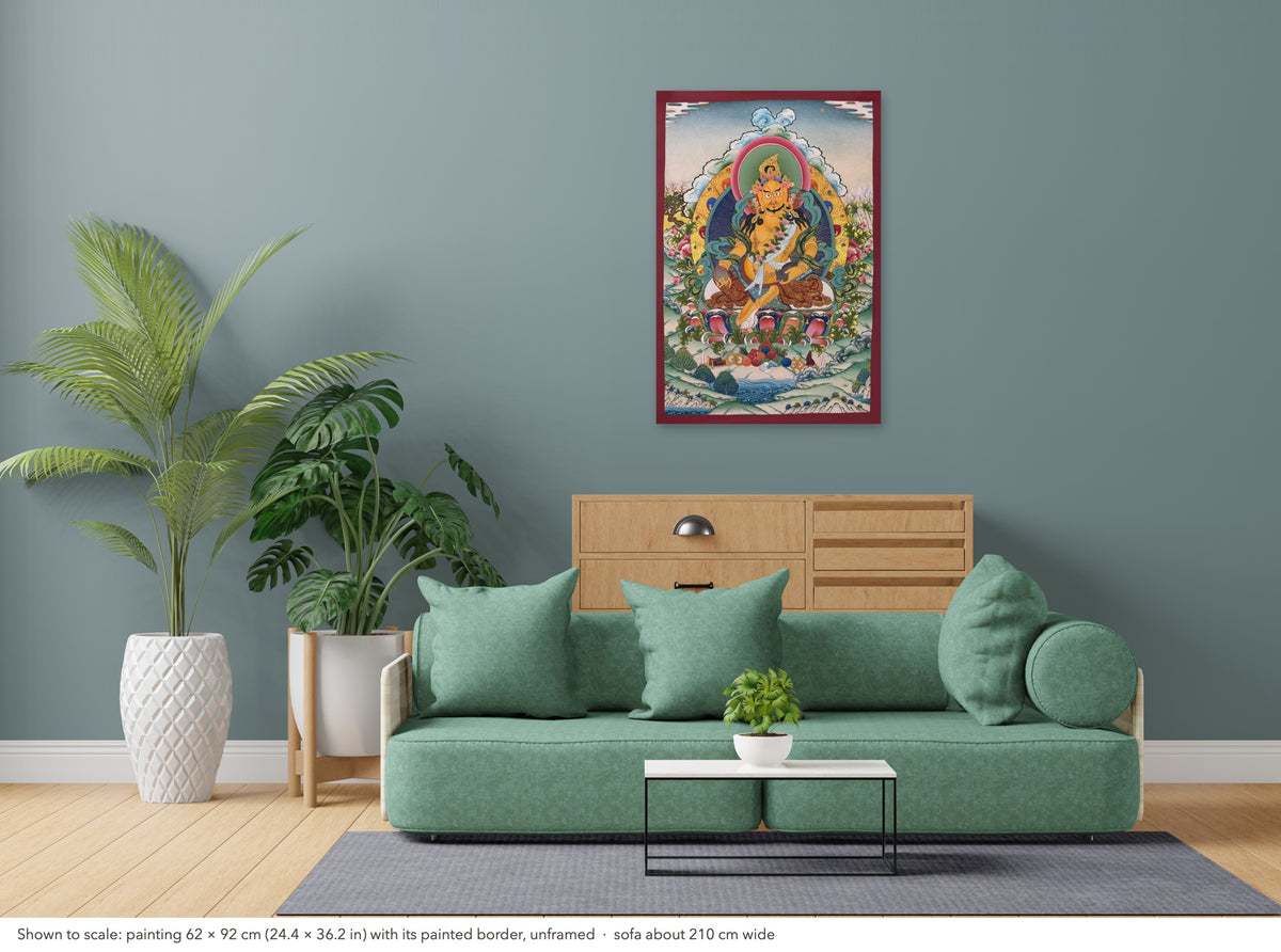 Jambhala thangka shown to scale in a living room, unframed, above a sofa about 210 cm wide (62×92 cm)