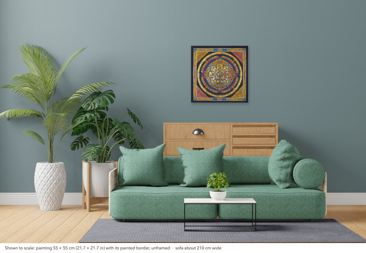 Kalachakra Mandala thangka shown to scale in a living room, unframed, above a sofa about 210 cm wide (55×55 cm)