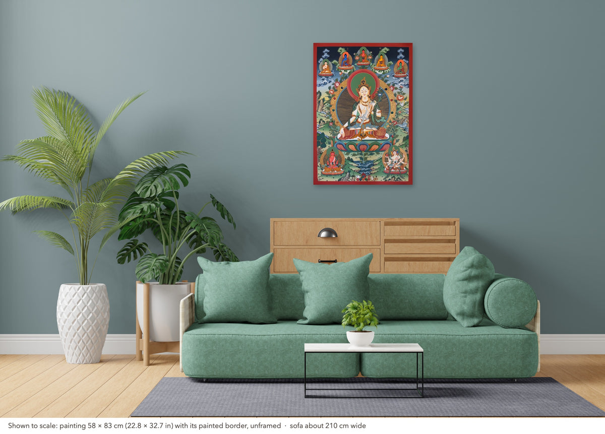 White Tara thangka shown to scale in a living room, unframed, above a sofa about 210 cm wide (58×83 cm)