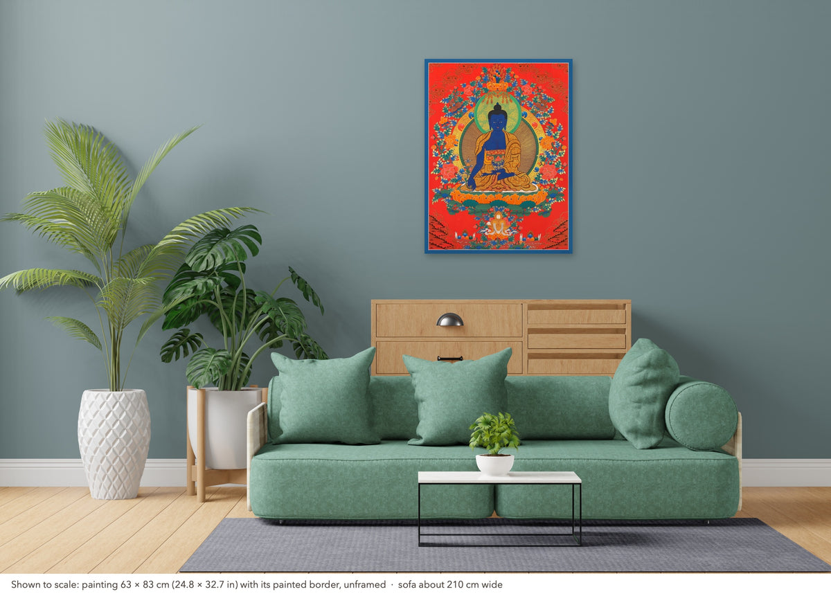Medicine Buddha thangka shown to scale in a living room, unframed, above a sofa about 210 cm wide (63×83 cm)