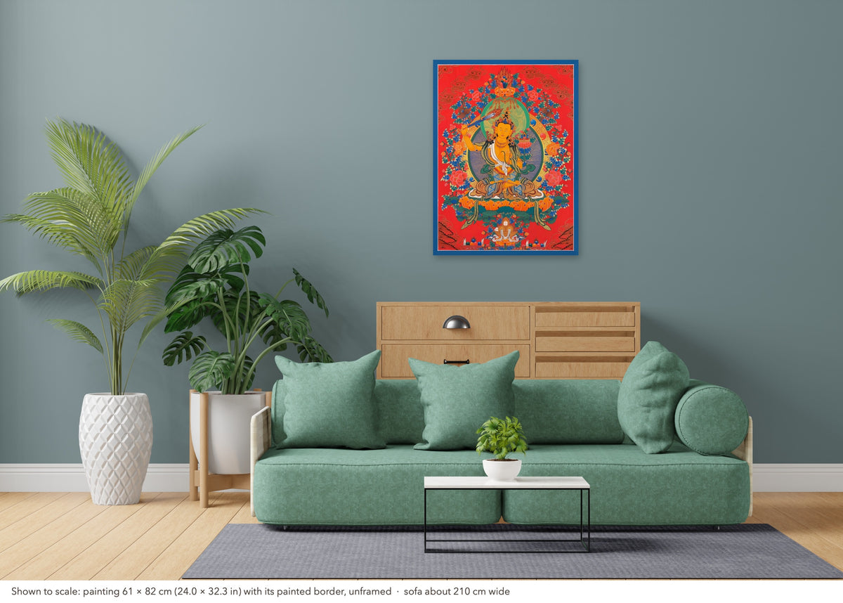 Manjushri thangka shown to scale in a living room, unframed, above a sofa about 210 cm wide (61×82 cm)