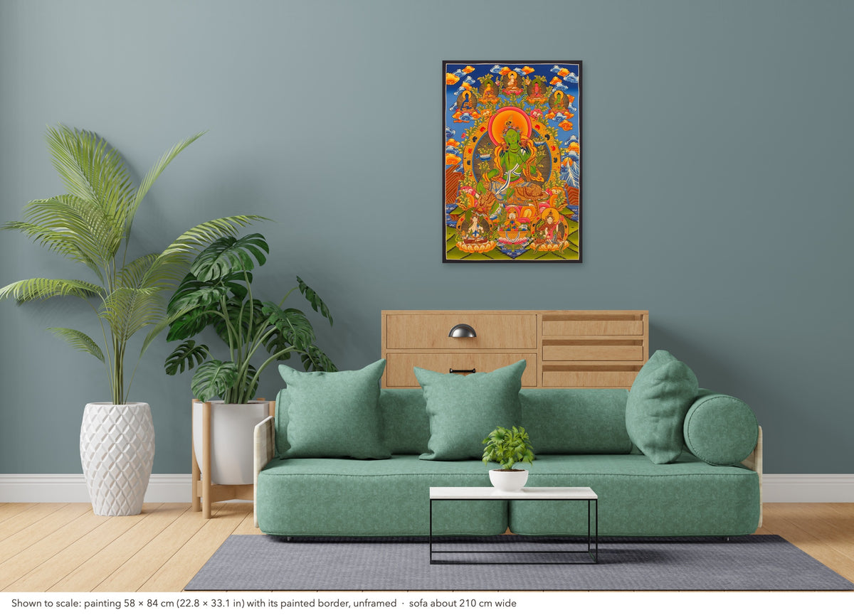 Green Tara thangka shown to scale in a living room, unframed, above a sofa about 210 cm wide (58×84 cm)