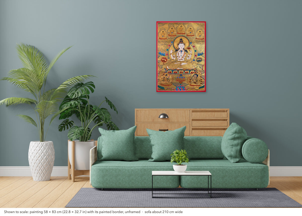 Chenrezig thangka shown to scale in a living room, unframed, above a sofa about 210 cm wide (58×83 cm)