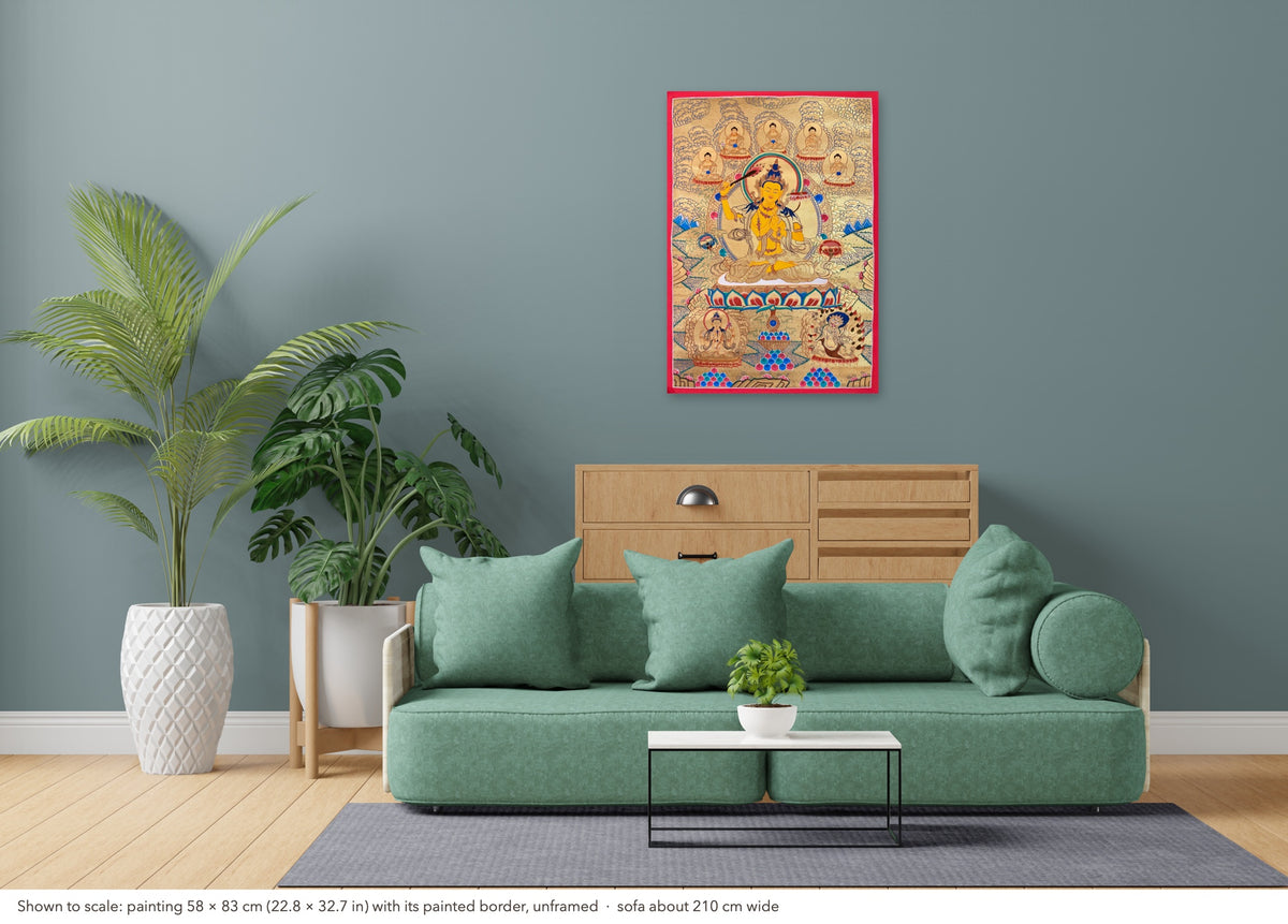 Manjushri thangka shown to scale in a living room, unframed, above a sofa about 210 cm wide (58×83 cm)