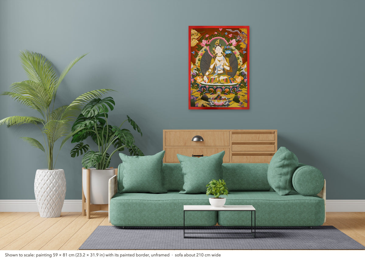 White Tara thangka shown to scale in a living room, unframed, above a sofa about 210 cm wide (59×81 cm)