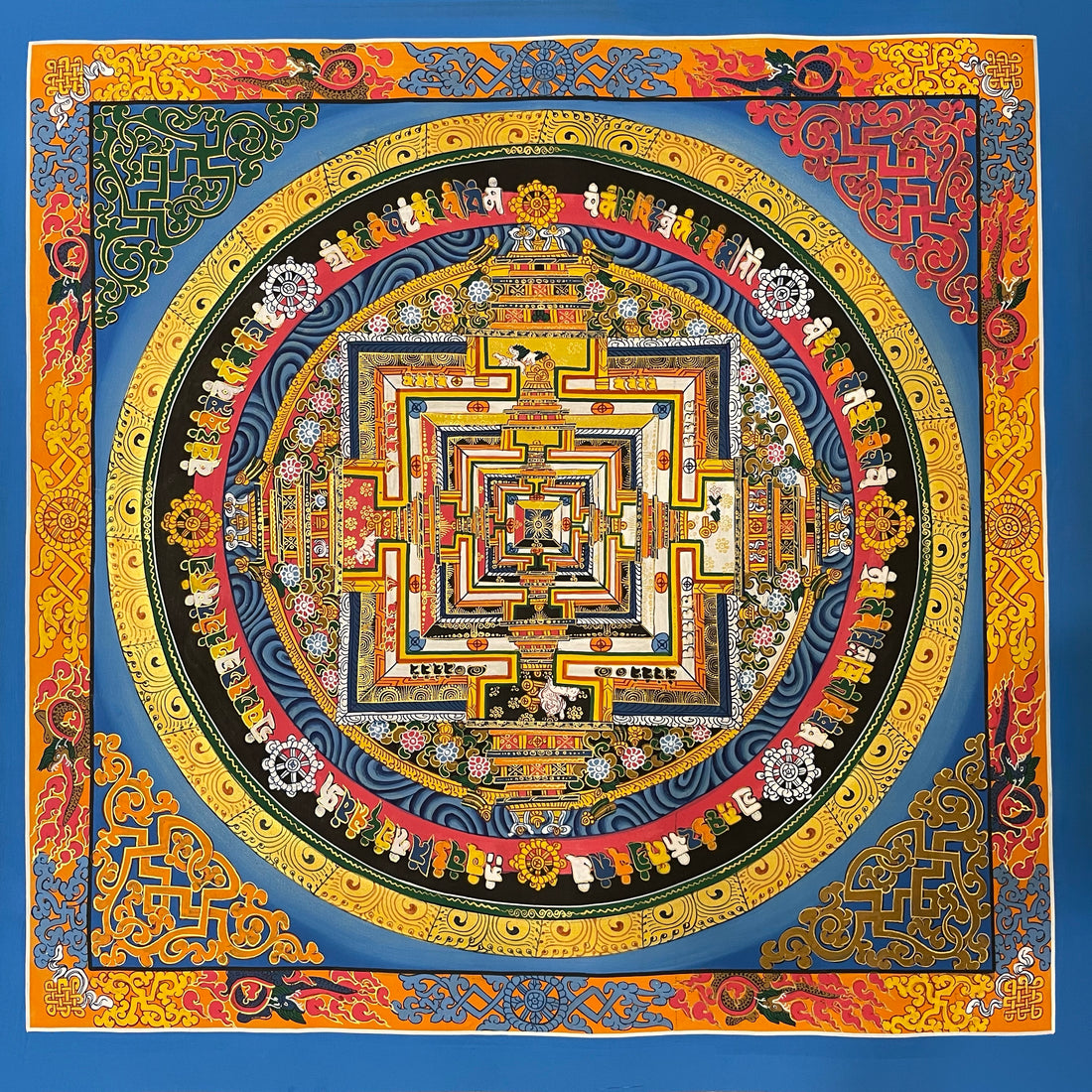 Kalachakra Mandala thangka, 55×55 cm: Kalachakra palace mandala on a bright blue ground, inside a border of dragons