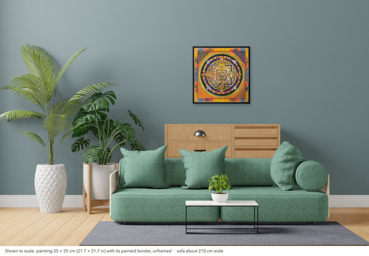 Kalachakra Mandala thangka shown to scale in a living room, unframed, above a sofa about 210 cm wide (55×55 cm)