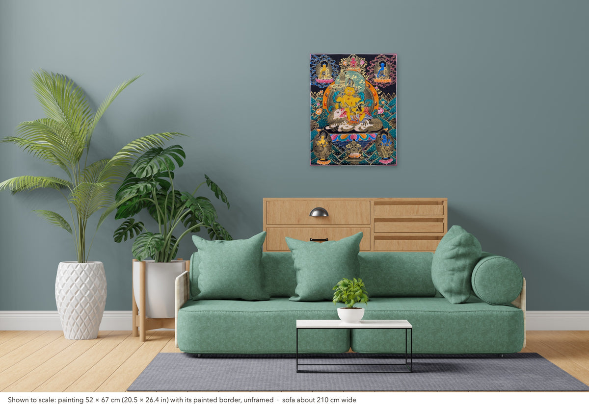 Vaishravana thangka shown to scale in a living room, unframed, above a sofa about 210 cm wide (52×67 cm)