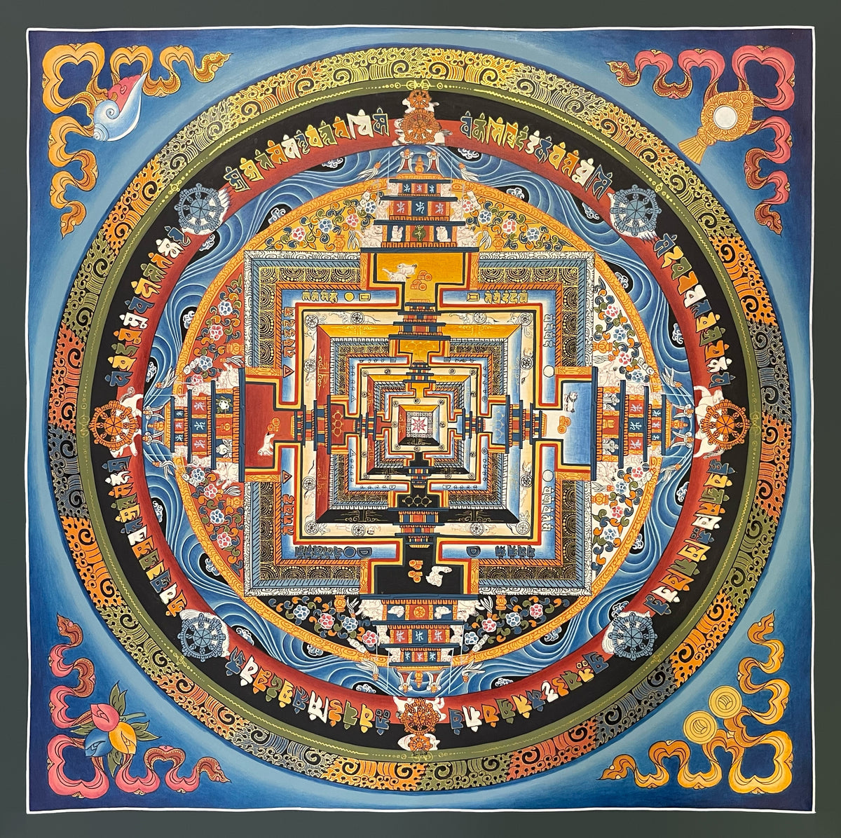 Kalachakra Mandala thangka, 55×55 cm: Kalachakra palace mandala with a red ring of coloured mantra syllables and dharma wheels, on a blue ground
