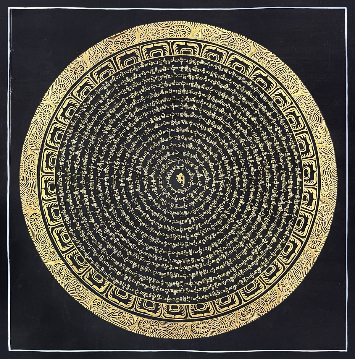 Mantra Mandala thangka, 54×54 cm: concentric rings of gold-coloured mantra script on black around a single syllable