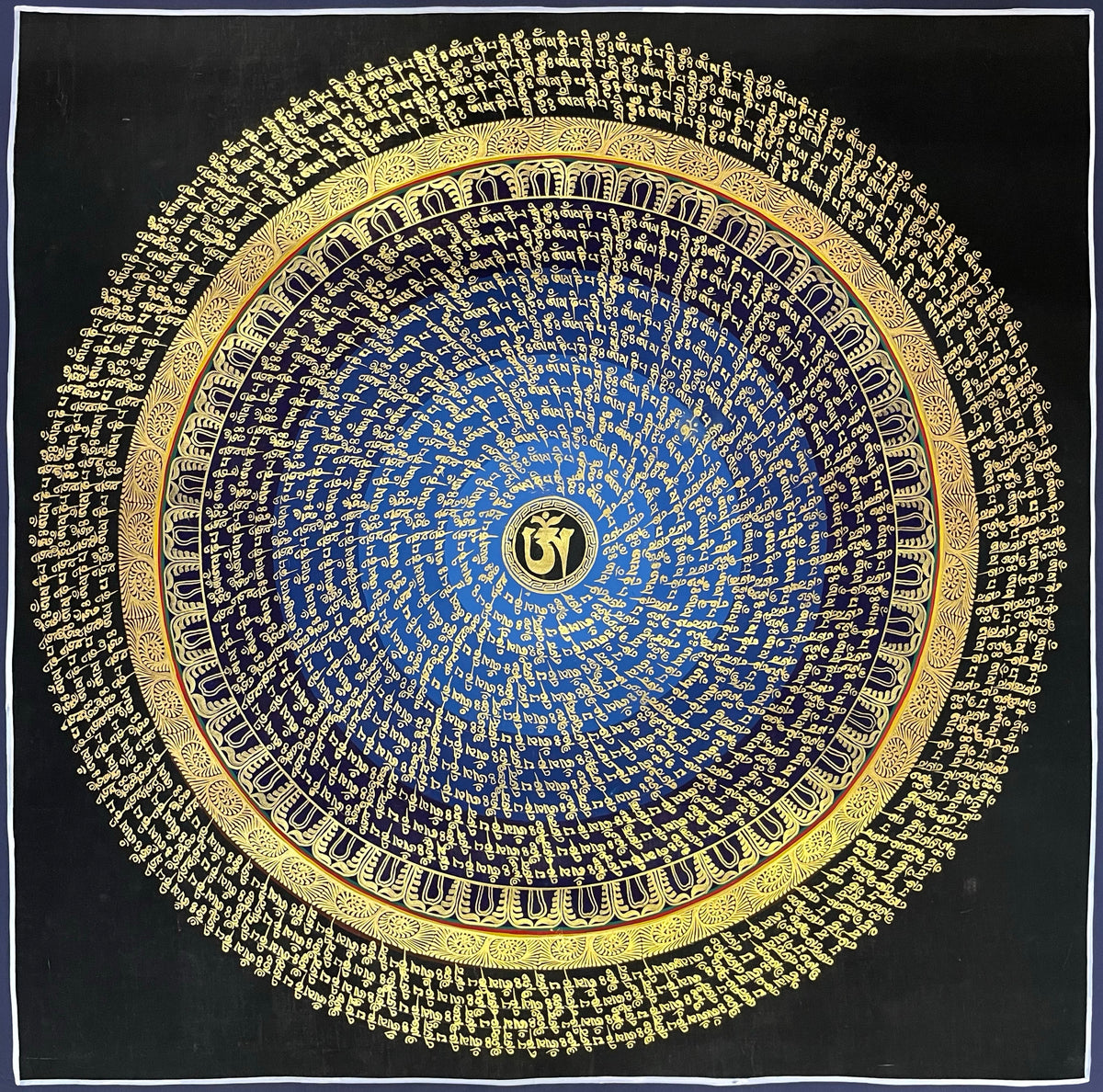 Mantra Mandala thangka, 75×75 cm: rings of gold-coloured mantra script on a blue disc around a central Om, with an outer ring of script on black