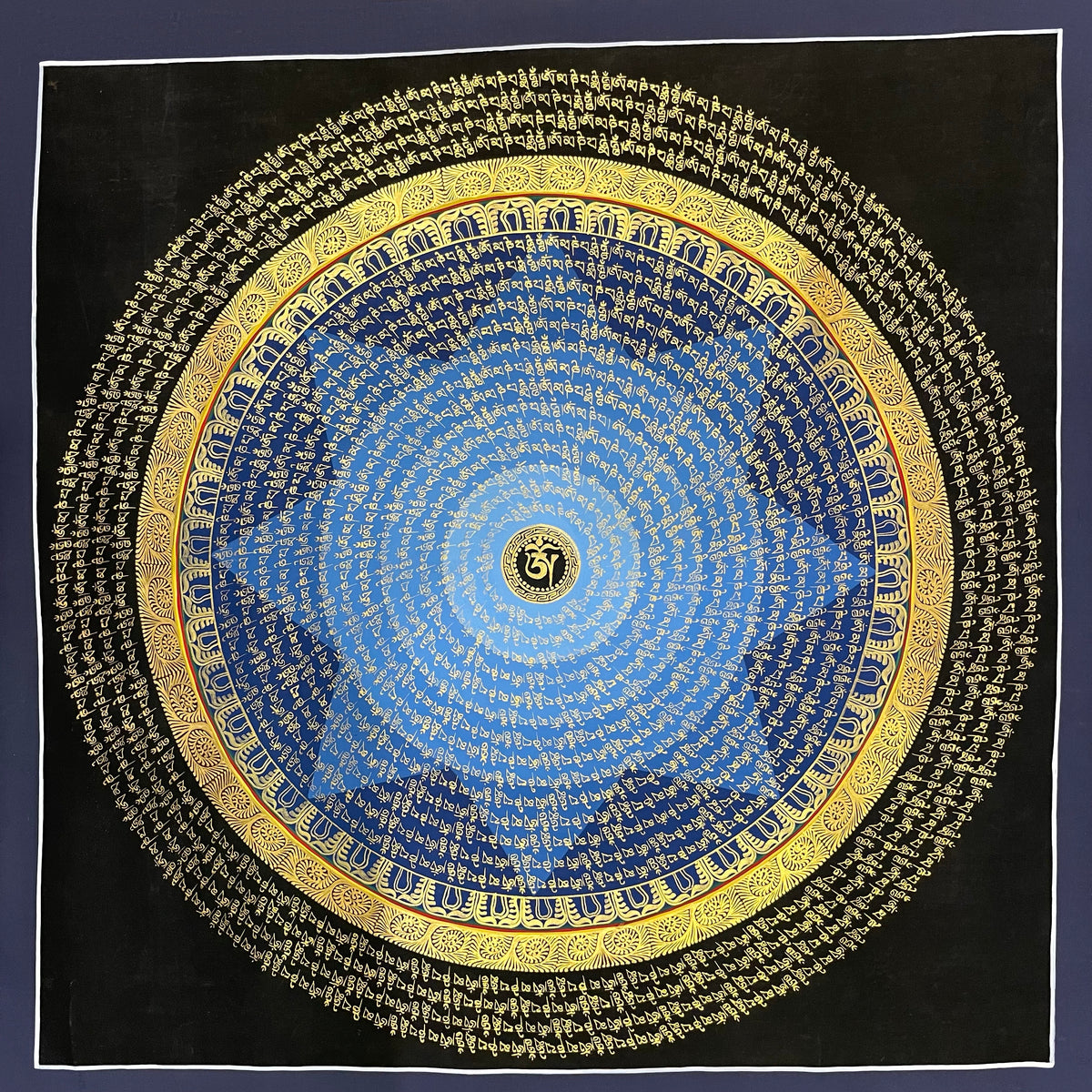 Mantra Mandala thangka, 75×75 cm: rings of gold-coloured mantra script on a blue disc around a central Om, with an outer ring of script on black