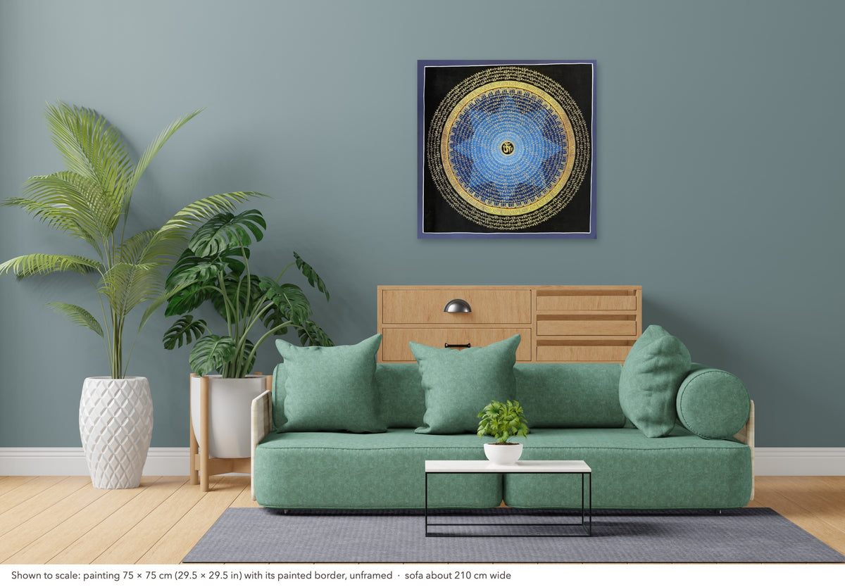 Mantra Mandala thangka shown to scale in a living room, unframed, above a sofa about 210 cm wide (75×75 cm)