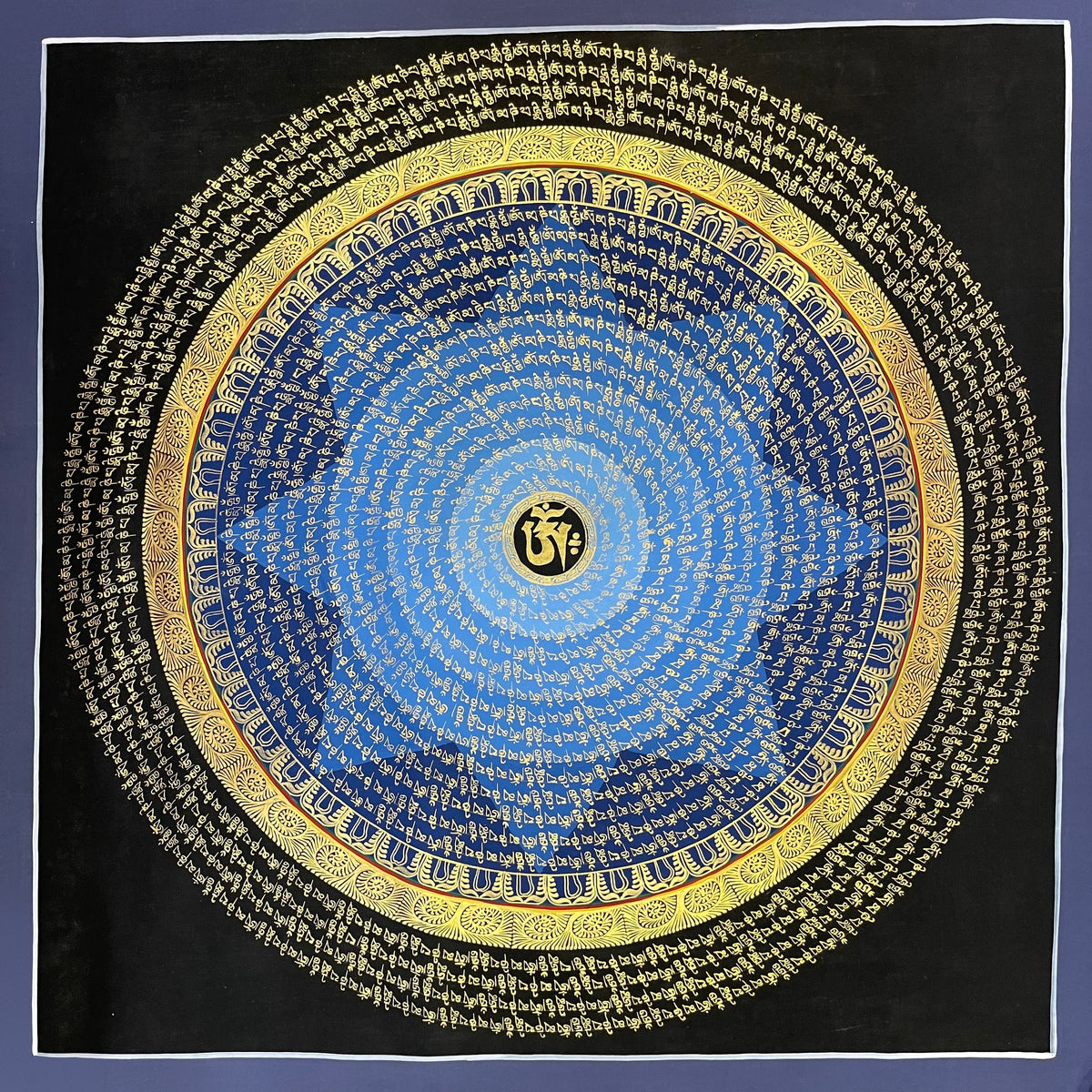 Mantra Mandala thangka, 75×75 cm: rings of gold-coloured mantra script on a blue disc around a central Om, with an outer ring of script on black