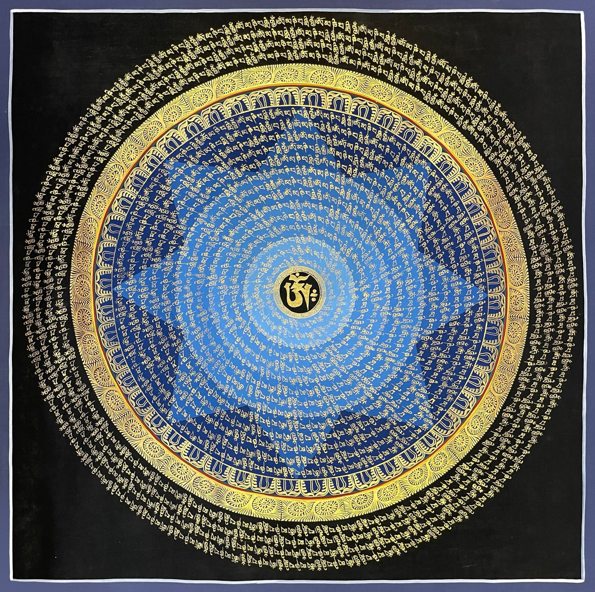 Mantra Mandala thangka, 75×75 cm: rings of gold-coloured mantra script on a blue disc around a central Om, with an outer ring of script on black