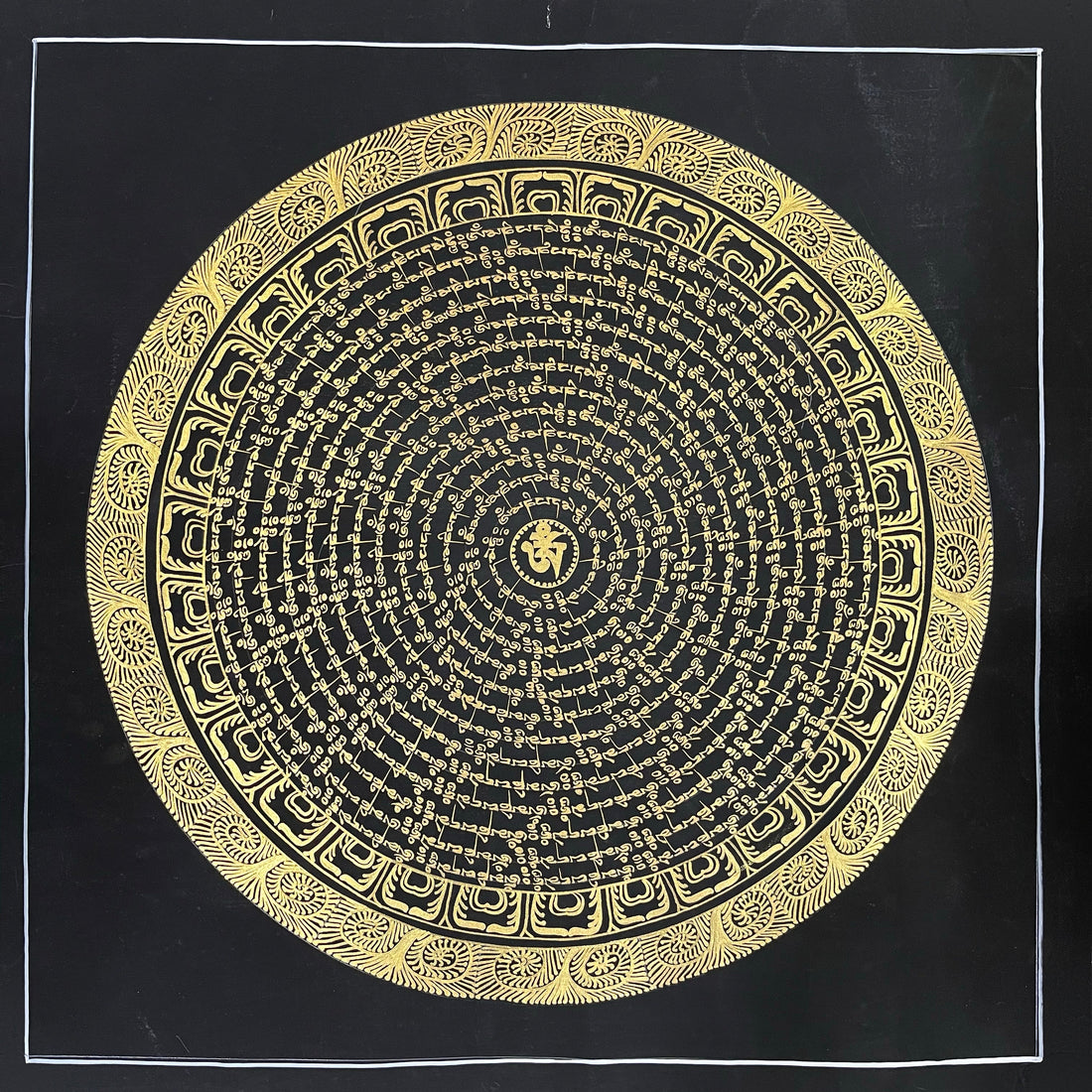 Mantra Mandala thangka, 54×54 cm: concentric rings of gold-coloured mantra script on black around a central Om